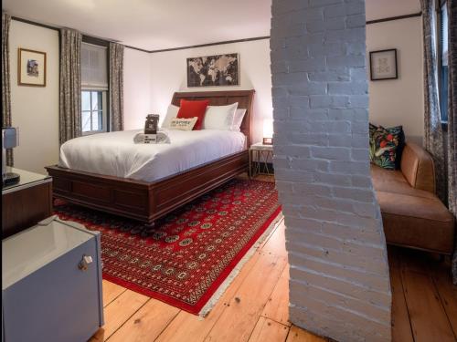 a bedroom with a bed and a red rug at Addison Choate in Rockport