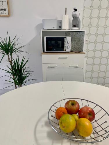 a bowl of fruit on a table in a kitchen at El Paraíso Agaete Valle in Agaete
