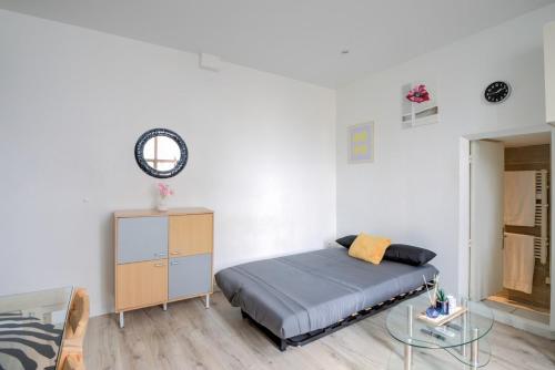 une chambre avec un lit et une table en verre dans l'établissement Studio 5, à Villeurbanne