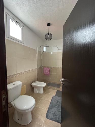 a bathroom with a toilet and a bidet at Celina Residence in Ribeira Brava