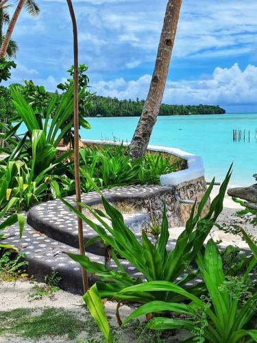 a tropical island with a beach and the ocean at Villa Tua, Beach Pool & Spa in Letman