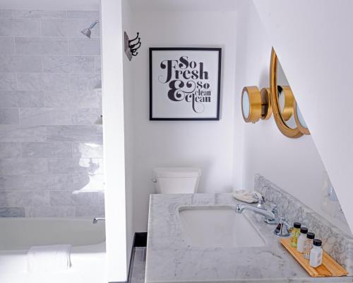 a bathroom with a sink and a picture on the wall at Addison Choate in Rockport