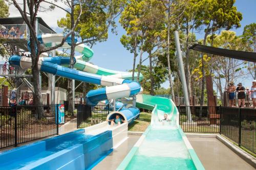 a water slide at a water park at Beach House with Fire Pit and Pizza Oven in Pialba