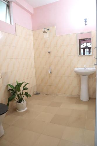 a bathroom with a sink and a toilet at Story House in Negombo