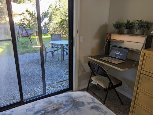 a bedroom with a desk with a laptop and a table at Stunning views near beaches and bluff in Sea Ranch