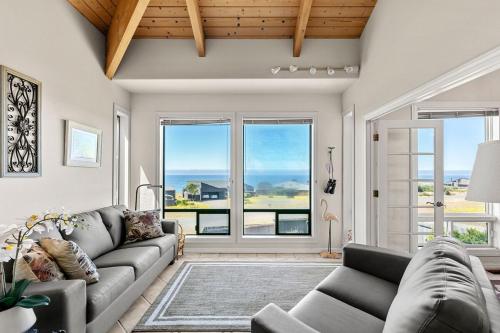 a living room with a couch and a view of the ocean at Stunning views near beaches and bluff in Sea Ranch