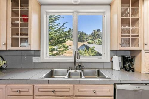 a kitchen with a sink and a window at Stunning views near beaches and bluff in Sea Ranch
