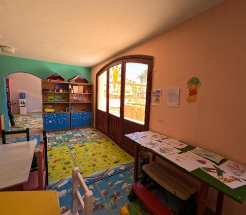 a childs room with a bedroom with a crib and a table at Royal Regency Club - Ultra All Inclusive in Sharm El Sheikh