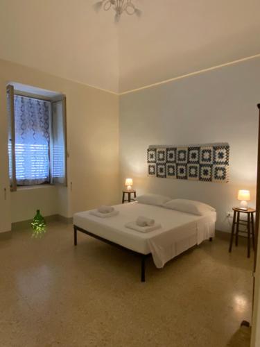 a bedroom with a large bed and a window at CASA 1960 in Vignacastrisi