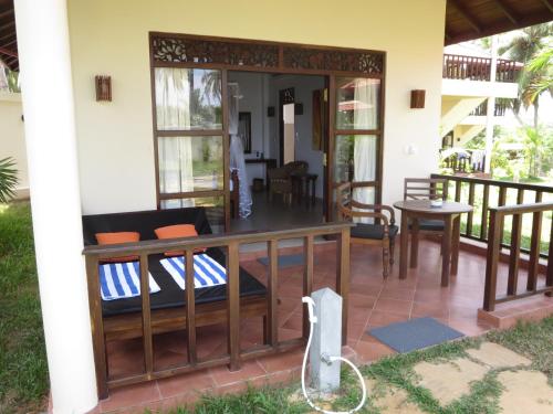 a screened in porch of a house at Lanka Beach Boutique Bungalows & Grand Villa in Tangalle