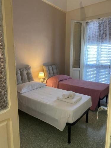 a bedroom with two beds and a window at CASA 1960 in Vignacastrisi