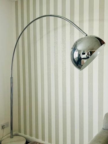 a lamp in a room with a striped wall at Luxury 2 bedroom apartment in Aberdeen in Kirkton of Skene