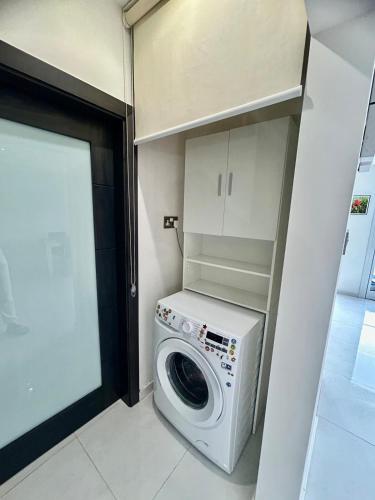 a washer and dryer in a small room at Luxury Seafront Apartment 3BR Ta Xbiex in Taʼ Xbiex