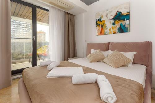 a bedroom with two beds with white towels on them at Astria Mediterana - Complex Novum in Olimp