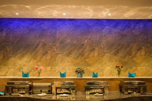 a bar with a counter with a purple wall at Aachman Nature Valley Resort Mashobra BY NAINA STAYCATION- Private Parking - Balcony and valley view Rooms in Shimla