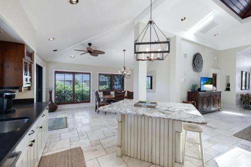 a kitchen with a island in the middle of a room at Serenity in Captiva