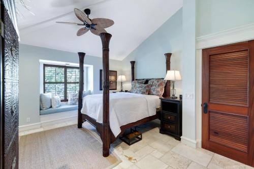 a bedroom with a bed and a ceiling fan at Serenity in Captiva