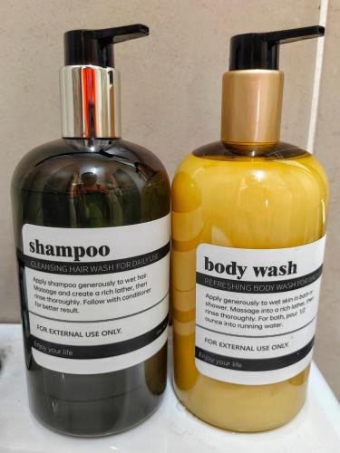 two bottles of shampoo and body wash sitting next to each other at Ayer Keroh B202 6pax Cozy Stay - GXHomes in Ayer Keroh