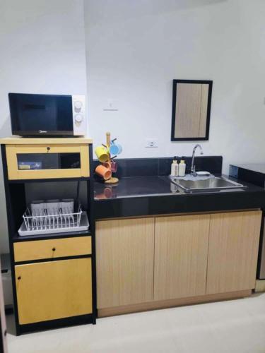 a kitchen with a sink and a counter top at Muntinlupa Staycation Leaf Residences in Manila