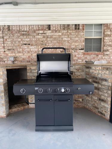 a grill in a garage with a brick wall at 4000 Sqft Lakefront Retreat Private Hot Tub #nh in Warr Acres