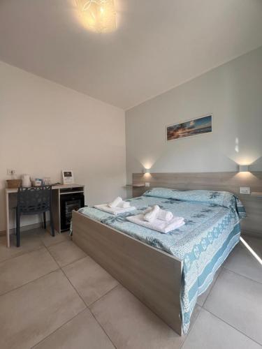 a bedroom with a bed with towels on it at Porta sul Mare in Tropea