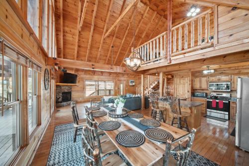 a dining room and kitchen with a table and chairs at Pet Friendly Family Cabin with Hot Tub & Game Room Near Dollywood in Pigeon Forge