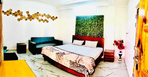 a bedroom with a bed and a couch at Hotel Mohan Kunj in Ayodhya