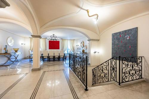 a living room with a staircase and a dining room at Palazzo Porta Picta in Bergamo