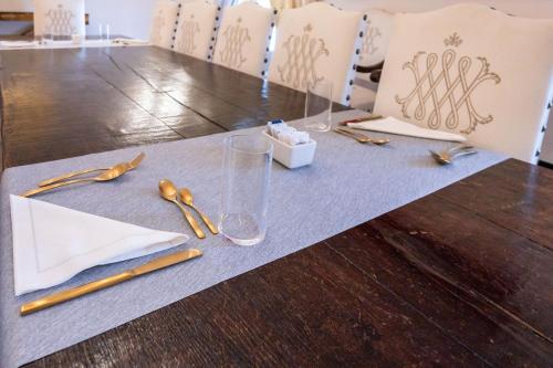 a table with gold utensils on a gray table cloth at Palazzo Porta Picta in Bergamo