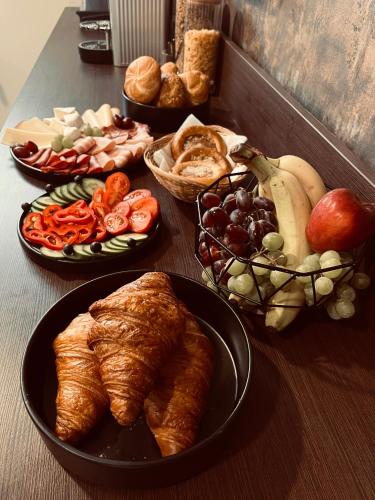 a table topped with different types of food on plates at Penzion Prestige Tennis Park in Frýdek-Místek
