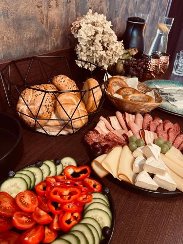 a table with three plates of different types of food at Penzion Prestige Tennis Park in Frýdek-Místek