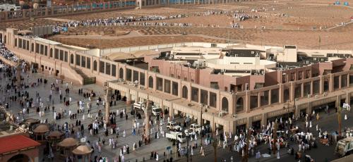 a group of people walking on a street at Pullman Zamzam Madina in Al Madinah