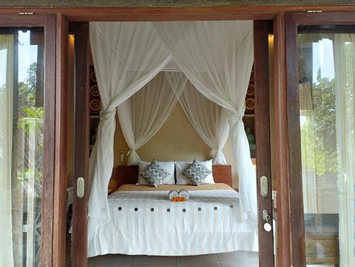 Postel nebo postele na pokoji v ubytování Umah Ubud Guest House