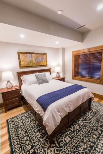a bedroom with a large bed and a rug at Mountain Lodge Oasis w Hot Tub-Rio Grande Trail in Carbondale