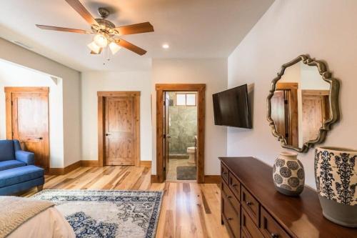 a bedroom with a ceiling fan and a mirror at Mountain Lodge Oasis w Hot Tub-Rio Grande Trail in Carbondale