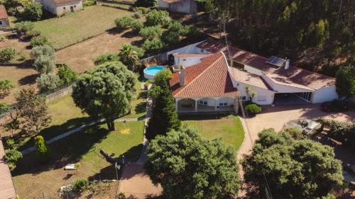 an aerial view of a house with a swimming pool at Casa das Milheirices in São Mamede