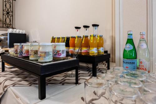 a group of bottles of drinks and glasses on a table at Palazzo Porta Picta in Bergamo