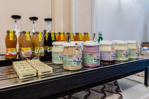 a table with a bunch of different types of jars of honey at Palazzo Porta Picta in Bergamo