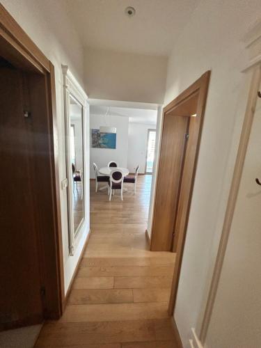 a hallway leading to a living room with a table at Apartments Krug in Budva