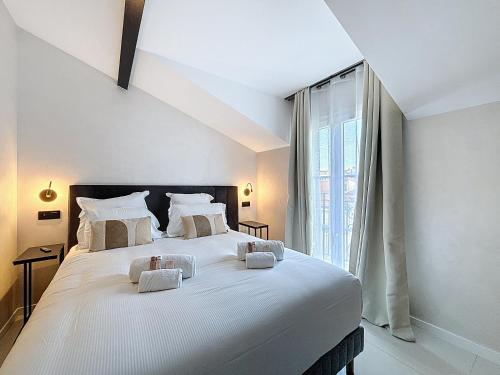a large white bed in a room with a window at Luxury Apartment - Central Cannes, near Beach & Palais - LRACANNES in Cannes