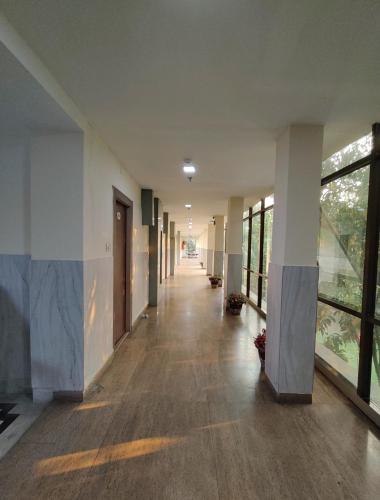 an empty hallway of an office building with windows at Sher-E-Punjab in Kolkata
