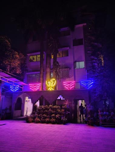 a building with purple and pink lights on it at Sher-E-Punjab in Kolkata