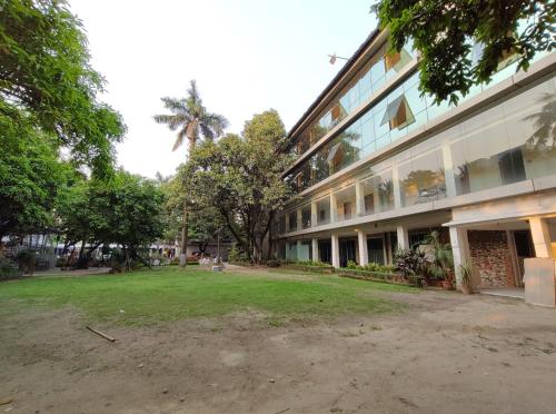 a building with a grass yard in front of it at Sher-E-Punjab in Kolkata