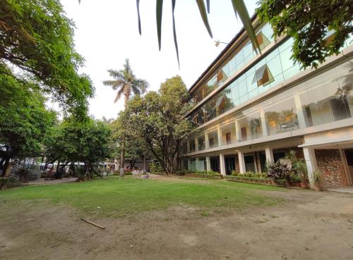 a building with a grass yard in front of it at Sher-E-Punjab in Kolkata