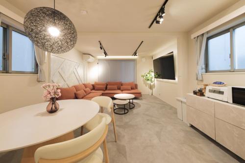 a living room with a white table and a couch at Make Your Hotel幡ヶ谷 in Tokyo