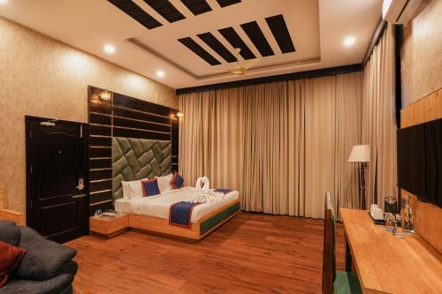 a bedroom with a king sized bed in a room at Hotel Bella Heights in Dharamshala