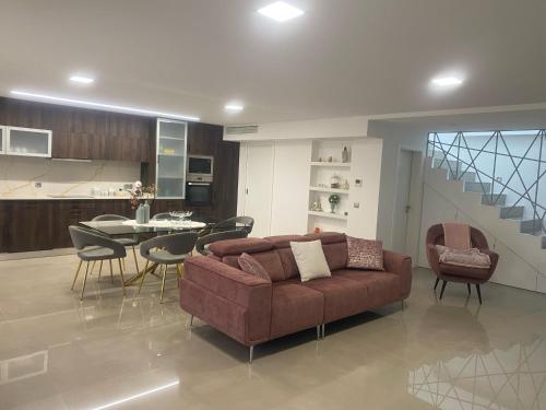 a living room with a couch and a table with chairs at Cantinho do Silvano in Gimonde