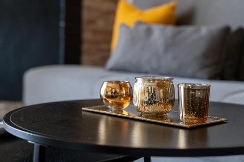 a tray with three glass cups on a table at Casa vacanze Aria in Leggiuno