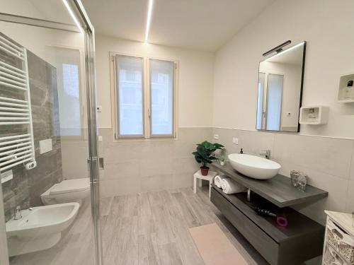 a bathroom with a sink and a toilet and a shower at Franciacorta Bergamo Airport Suite Apartment in Telgate