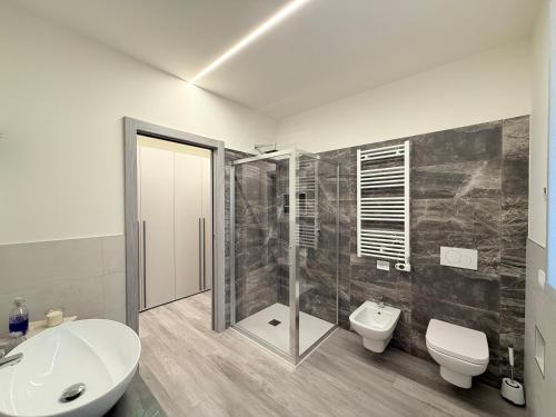 a bathroom with a shower and a toilet and a sink at Franciacorta Bergamo Airport Suite Apartment in Telgate